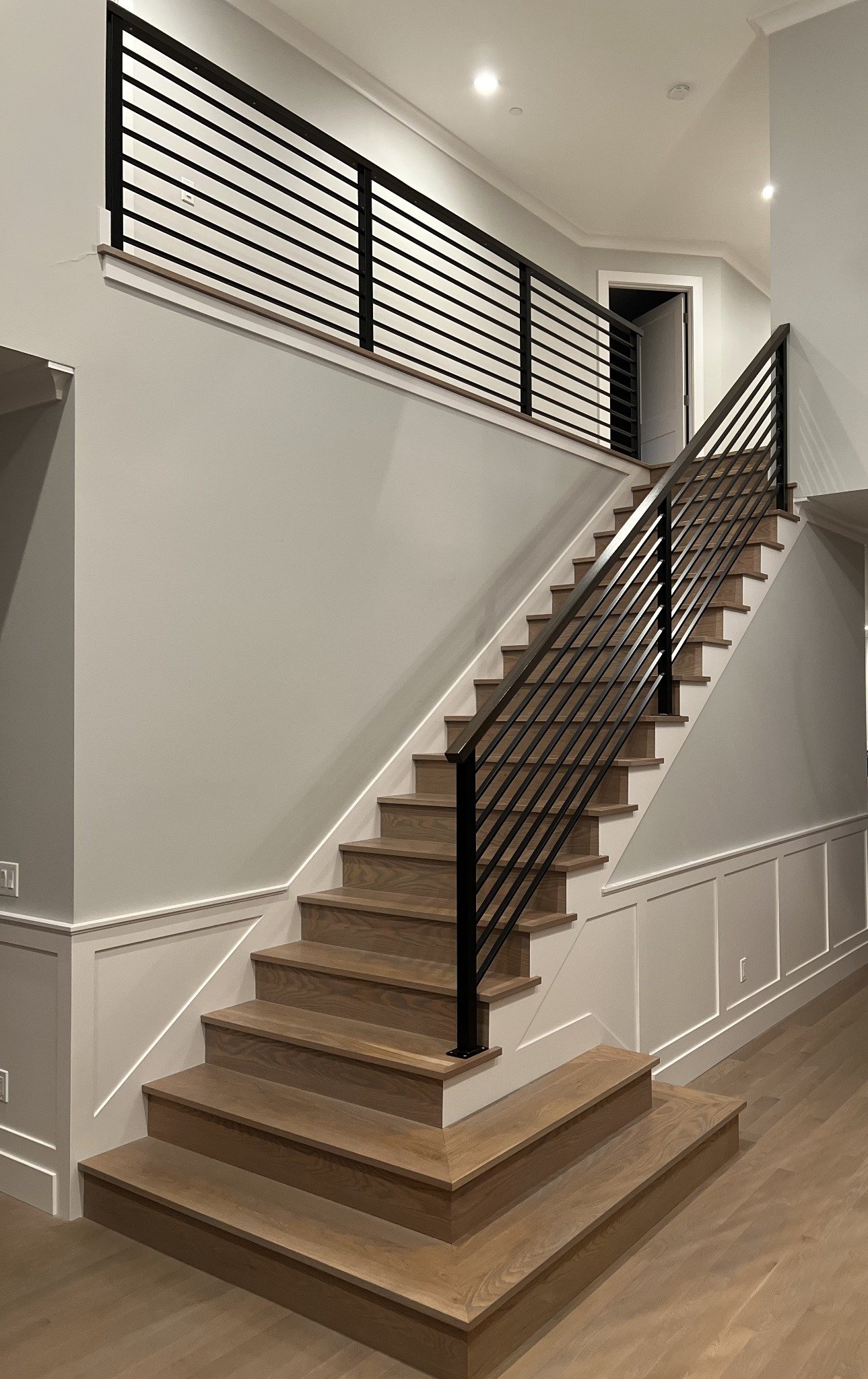 Custom staircase with black metal railing